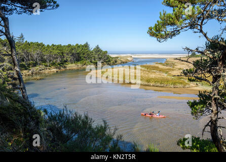 Couple paddling kayak on the Siltcoos River, Oregon Dunes National Recreation Area, Oregon Coast. Stock Photo