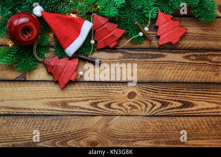 Christmas Background with Santa hat and red vintage decoration over wooden planks Stock Photo