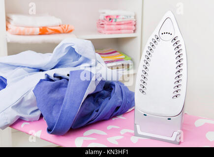Iron on ironing board Stock Photo