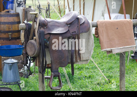 old western saddle on a hitching post in the wild west Stock Photo