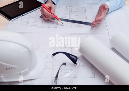 Chief engineer or architect works with building drawings Stock Photo