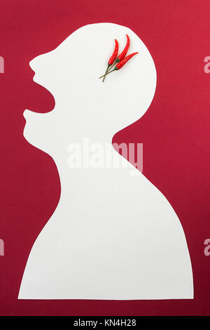 concept of human disease, suffering and stinging pain, thrills - abstract white male man isolated on red background screaming open mouth from multiple severe headaches, burning pain such as chili. Stock Photo