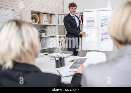 Young Man Presenting Project in Office Stock Photo