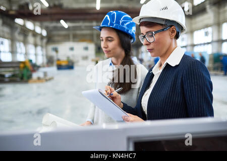 Female Inspectors Wrapped up in Work Stock Photo