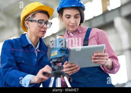 Pretty Surveyors Focused on Work Stock Photo