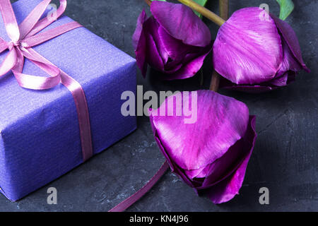 Box with a gift and a bouquet of tulips. Valentine Day Stock Photo
