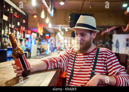 Bearded Young Man Chilling in Pub Stock Photo