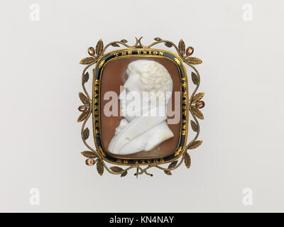 A finely carved cameo relief depicting a classical portrait rendered in gemstone or shell. Used historically as personal adornment, it exemplifies ancient craftsmanship and detailed relief sculpture. Stock Photo
