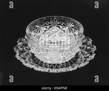 Finger bowl and plate set from a historical period, used for hand cleansing during meals, demonstrating craftsmanship, design, and dining refinement. Stock Photo