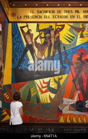 Tourist looking at the Mural of Discovery of Amazon by Oswaldo Guayasamin; Presidential Palace ( Carondelet Palace ), Quito, Ecuador South America Stock Photo
