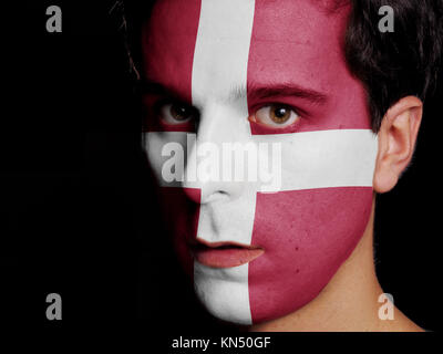 Flag of Denmark Painted on a Face of a Young Man.