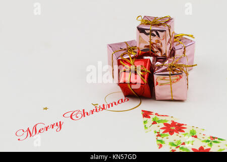Merry Christmas card with stack of shiny presents Stock Photo
