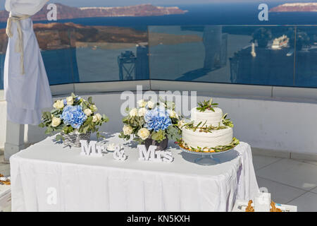 Decorations with flowers and cake for the wedding on the background of the sea Stock Photo