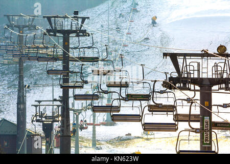 Ski lift with empty seats over the snow mountain in ski resort Stock Photo