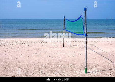 Beach volleyball net set up and waves and blue sky in background Stock  Photo - Alamy