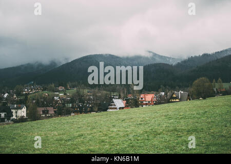 Zakopane in spring with the Tatra mountains covered in clouds on an overcast day Stock Photo