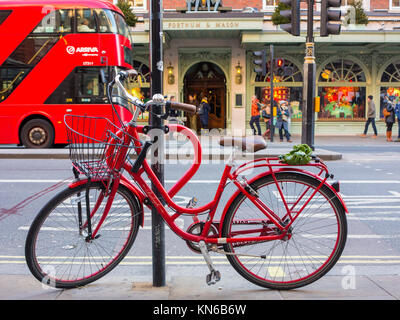 A smart red bicycle parked on Piccadilly outside Fortnum & Masons Stock Photo
