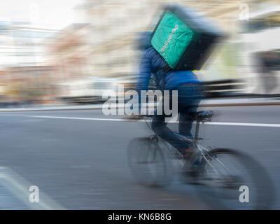 A Deliveroo cyclist on Piccadilly in London Stock Photo