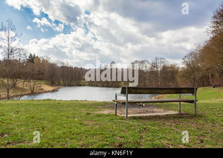 Relaxing Park Bench View over Water Forest Landscape Peaceful Tranquil Sunny Sky Stock Photo