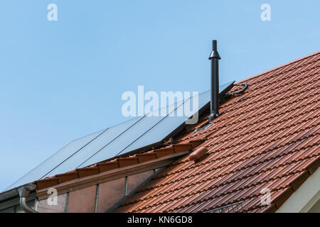 German House Orange Ceramic Tiles Solar Water Heater Blue Sky Sustainable Residential Stock Photo