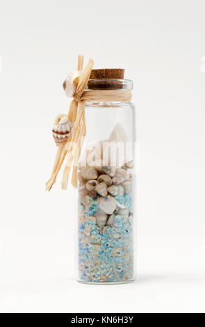 Small glass bottle filled with sea memories Stock Photo