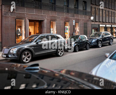 Bentley Bentayga's with Smart car parked in Albemarle Street London UK Stock Photo
