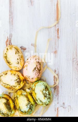 Golden Easter Eggs on white wooden background, Easter Concept, Space for Text Stock Photo