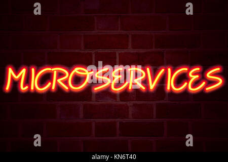 Microservices neon sign on brick wall background. Fluorescent Neon tube Sign on brickwork Business concept for Micro Services 3D rendered Front View Stock Photo