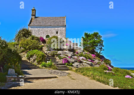 The pretty Chapelle Sainte Barbe (1619) is perched on a hilltop overlooking Roscoff Bay in Brittany northern France is a popular visitor attraction. Stock Photo