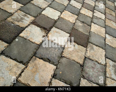 Pavement made from old grey concrete tiles Stock Photo