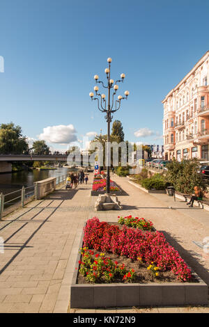 people walking  along the banks of the river Brda in the Polish city of Bydgoszcz Poland  enjoying the sunshine Stock Photo