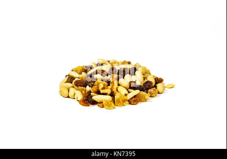 On a white background there is a handful of a mixture of nuts, raisins and candied fruits Stock Photo