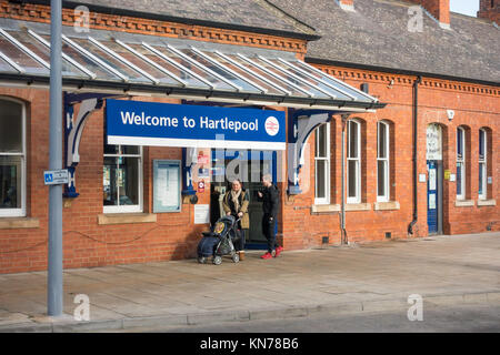The entrance to the railway or train station at Hartlepool town centre a couple with a child in a baby buggy exiting Stock Photo