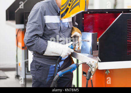 Worker with protective mask welding metal Stock Photo