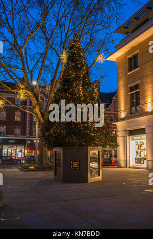 LONDON, UK - DECEMBER 09, 2017: Decorated Christmas tree on Duke of York Square just off the fashionable King's Road in Chelsea, London, which offers  Stock Photo