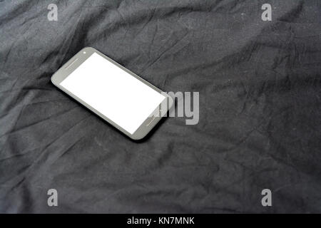 Cell Phone on Black Blanket White Screen Isolated Simple Background Fabric Stock Photo