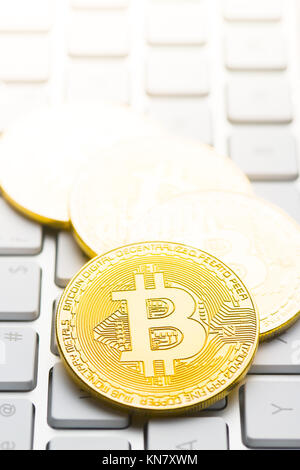 Golden bitcoins. Cryptocurrency on computer keyboard. Stock Photo
