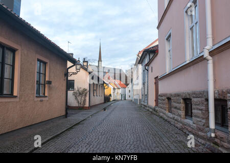 Vadstena, Sweden- December 9th, 2017: Street pictures of Vadstena town with the spire of Saint Bridget church in the backround Stock Photo