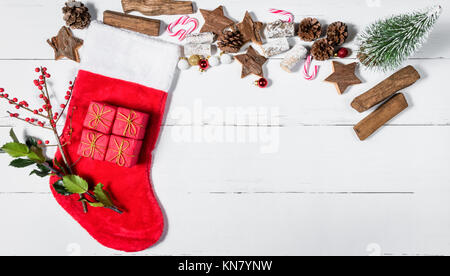 Christmas Stocking and Ornaments on White Wooden Table Stock Photo