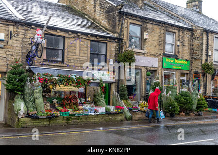 Holmfirth, UK. 10th Dec, 2017. Lonley shopper as snow hits the peak district town of Holmfirth, West Yorkshire, England. 10th December 2017. Carl Dickinson/Alamy Live News. Credit: CARL DICKINSON/Alamy Live News Stock Photo