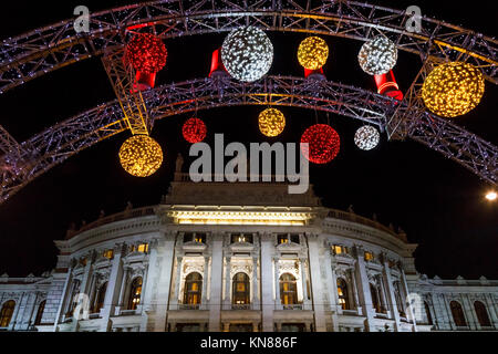 Vienna, Austria, 10th December 2017. The Burgtheater, framed by the illuminated entrance feature of the traditional festive season Viennese Christmas Market in Rathausplatz (Christkindlmarkt am Rathausplatz, Wiener Christkindlmarkt), the largest yuletide market in Vienna, situated by the Neues Rathaus (new city hall) in the Museum Quarter of central Vienna (Innere Stadt). Credit: Graham Prentice/Alamy Live News. Stock Photo