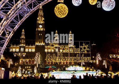 Vienna, Austria, 10th December 2017. Illuminated Frohe Weihnachten (Happy Christmas) sign at the entrance to traditional festive season Viennese Christmas Market in Rathausplatz (Christkindlmarkt am Rathausplatz, Wiener Christkindlmarkt), the largest yuletide market in Vienna, situated by the Neues Rathaus (new city hall) in the Museum Quarter of central Vienna (Innere Stadt). Credit: Graham Prentice/Alamy Live News. Stock Photo