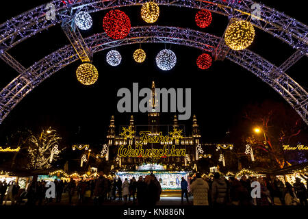 Vienna, Austria, 10th December 2017. Illuminated entrance arch and Frohe Weihnachten (Happy Christmas) sign at the traditional festive season Viennese Christmas Market in Rathausplatz (Christkindlmarkt am Rathausplatz, Wiener Christkindlmarkt), the largest yuletide market in Vienna, situated by the Neues Rathaus (new city hall) in the Museum Quarter of central Vienna (Innere Stadt). Credit: Graham Prentice/Alamy Live News. Stock Photo