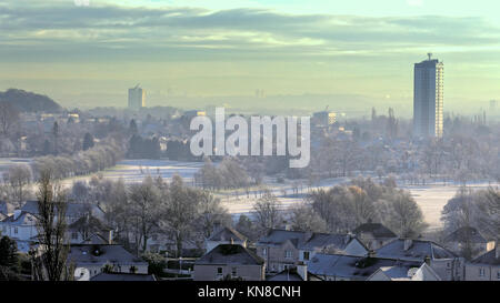 Glasgow, Scotland, UK  11th December. UK Weather:Freezing temperatures and bright sunshine causes winter whiteout  behind one of the towers of Scotstoun and white greens on knightswood golf course. Credit Gerard Ferry/Alamy news Stock Photo