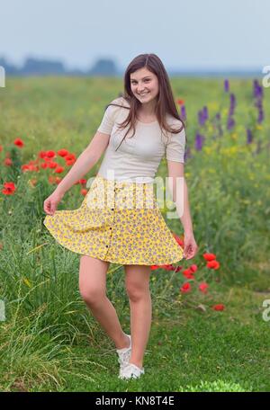 Smiling young girl on summer field.