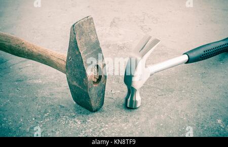 Hammer still life. Two hammers side by side on a stone workbench. Symbol of strength and force. Concept of industrial work tool, carpentry equipment
