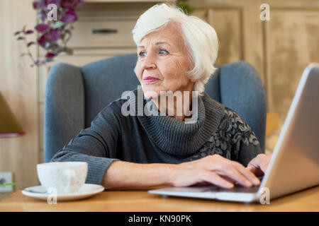 Elegant Senior Woman Using Laptop Stock Photo