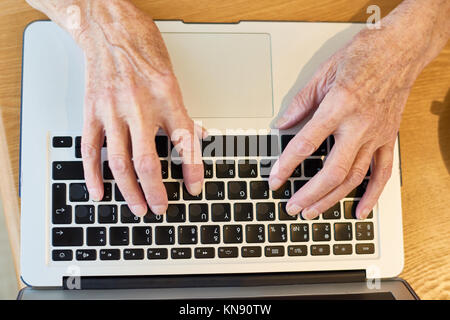 Hands of Senior Woman Typing Stock Photo