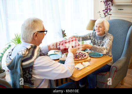 Senior Couple Exchanging Gifts Stock Photo