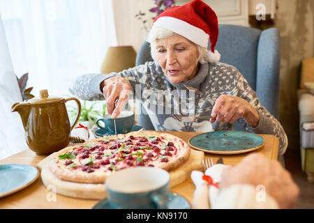 Grandma Serving Pie on Christmas Stock Photo